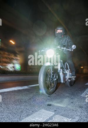 Man riding his electric motorcycle through Bangkok Stock Photo - Alamy