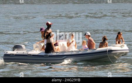 Matt Damon with wife and daughter and fellow Ocean's Eleven actor Don Cheadle on holiday as guests at George Clooney's villa in Laglio, Lake Como, Italy. Stock Photo