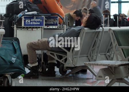 European airports are still at a stand still caused by Icelandic volcano Eyjafjollajokull. Passengers waiting in Rome Fiumicino airport, Rome Stock Photo