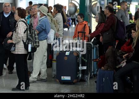 European airports are still at a stand still caused by Icelandic volcano Eyjafjollajokull. Passengers waiting in Rome Fiumicino airport, Rome Stock Photo