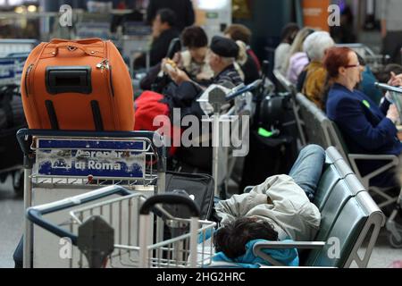 European airports are still at a stand still caused by Icelandic volcano Eyjafjollajokull. Passengers waiting in Rome Fiumicino airport, Rome Stock Photo