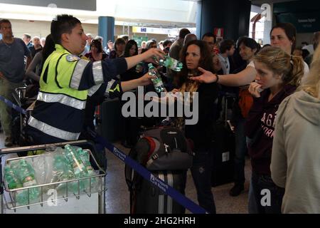 European airports are still at a stand still caused by Icelandic volcano Eyjafjollajokull. Passengers waiting in Rome Fiumicino airport, Rome Stock Photo