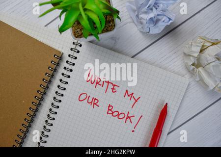 Write My Our Book write on a book isolated on Wooden Table. Stock Photo