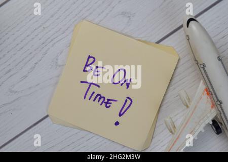 Be On Time write on sticky notes isolated on Wooden Table. Stock Photo