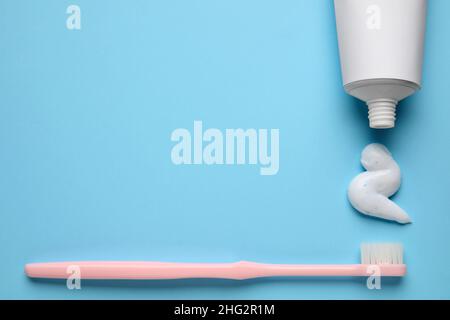 Toothbrush and toothpaste squeezed from tube on color background Stock Photo