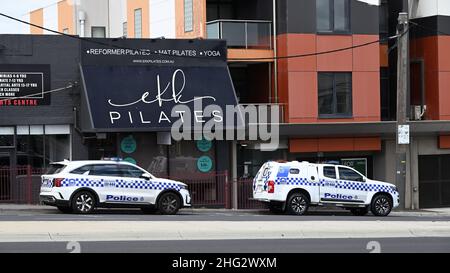 Two Victoria Police vehicles, a Kia Sorento and a Holden Colorado, parked in front of shops at Ormond Shopping Centre on North Rd Stock Photo