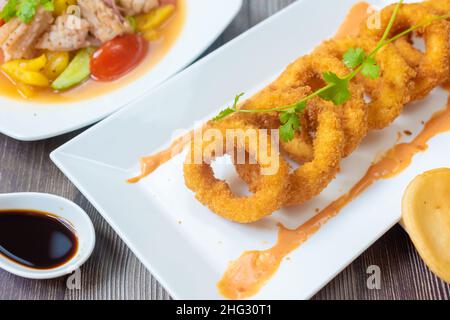 Crispy fried squid rolls.  Ingredients include fresh squid and ruffles and spices Stock Photo