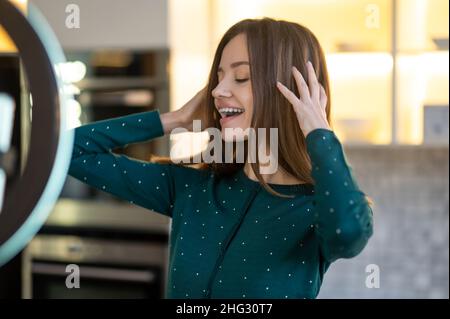 Cute young woman making a workshop on haircare Stock Photo