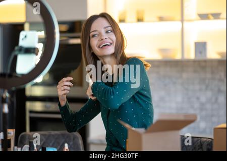 Cute young woman making a workshop on haircare Stock Photo