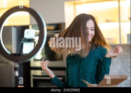 Cute young woman making a workshop on haircare Stock Photo