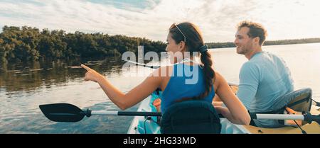 Kayak Eco Tour tourists kayaking in the mangroves of the Everglades, Keys, Florida, USA travel. Happy man and woman looking at the wildlife in nature Stock Photo