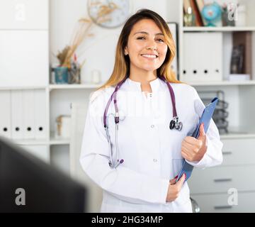 Latina female doctor standing in office Stock Photo