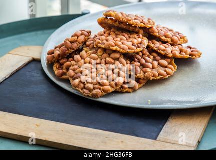 Traditional Thai Snack : Peanut crackers made from nuts and flour to fry on plate. Deep Fried Bean cookies peanut, Selective focus. Stock Photo