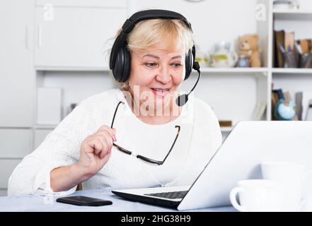 Mature woman communicates via the Internet Stock Photo