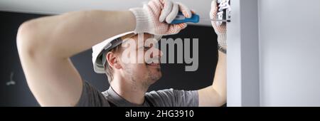 Man installing wooden door hinges Stock Photo