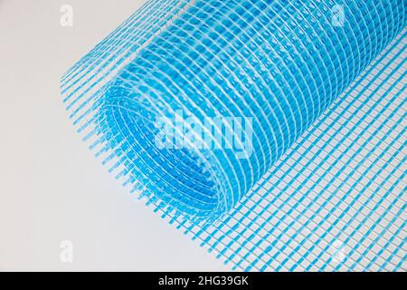 Blue reinforcing construction mesh for wall strengthening on white background, isolate. Stock Photo