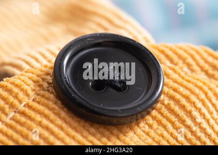 Brown corduroy material with button, macro, Stock Photo