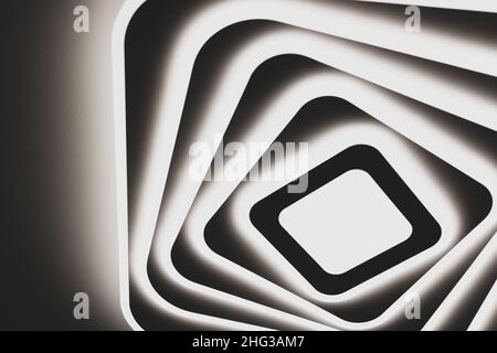 Bright LED lamp on the ceiling of the house. Abstract image in squares and rhombuses, warm dark tones. Stock Photo