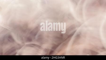 Horizontal abstract beige background banner made of thin lines and curled copper waves. Soft blur and bright highlights on the surface. Stock Photo