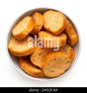 Olive and tomato bruschetta chips in a white ceramic bowl isolated on white. Top view. Stock Photo