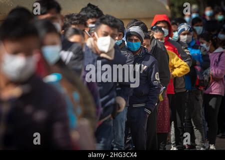 Kathmandu, Bagmati, Nepal. 18th Jan, 2022. People stand in line waiting for their turn to get inoculated with anti-COVID vaccines at Teku Hospital in Nepali capital Kathmandu. Serpetine lines stretching far and wide as government makes vaccination card mandatory to take public services or to be at public areas starting from 21 January, 2022. (Credit Image: © Amit Machamasi/ZUMA Press Wire) Stock Photo