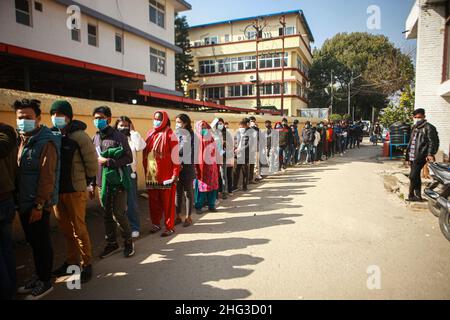 Kathmandu, Bagmati, Nepal. 18th Jan, 2022. People stand in line waiting for their turn to get inoculated with anti-COVID vaccines at Teku Hospital in Nepali capital Kathmandu. Serpetine lines stretching far and wide as government makes vaccination card mandatory to take public services or to be at public areas starting from 21 January, 2022. (Credit Image: © Amit Machamasi/ZUMA Press Wire) Stock Photo