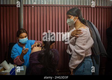 Kathmandu, Bagmati, Nepal. 18th Jan, 2022. A paramedic inoculates a person with anti-COVID vaccine at Teku Hospital in Nepali capital Kathmandu. Serpetine lines stretching far and wide as government makes vaccination card mandatory to take public services or to be at public areas starting from 21 January, 2022. (Credit Image: © Amit Machamasi/ZUMA Press Wire) Stock Photo