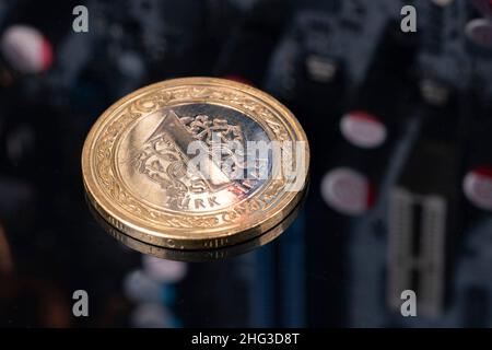 One Turkish Lira coin on CPU circuit board. Real money from Turkey. Online trading. Payment system. Technology business background with copy space Stock Photo
