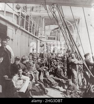 Archival photo of emigrants on the crowded lower deck of a ship, in mid-ocean. 1890 Stock Photo