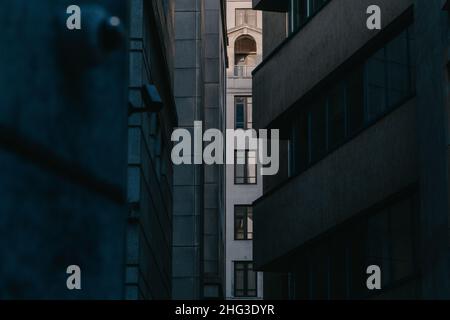 Windows of a commercial office building beyond an alleyway, surveilled by a CCTV camera in the city of london, london, UK Stock Photo