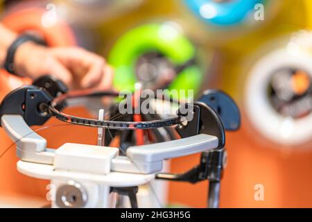 manual stringing of a badminton racket in service Stock Photo