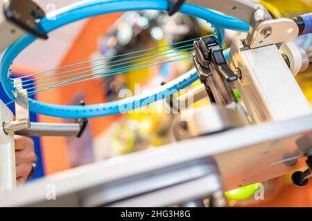 manual stringing of a tennis racket in service Stock Photo