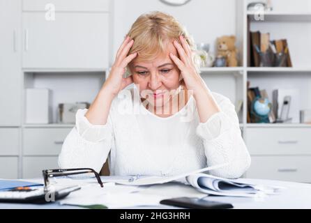 Woman engaged in home accounting Stock Photo