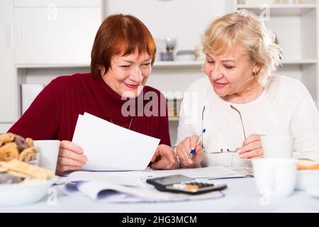 Cheerful elderly women with documents Stock Photo