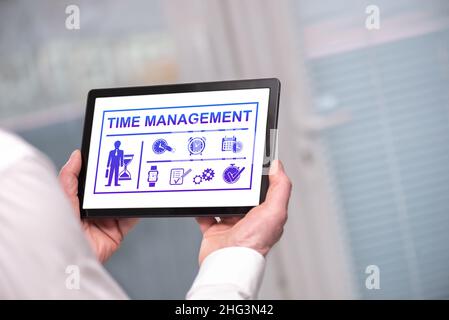 Time management concept shown on a tablet held by a man Stock Photo