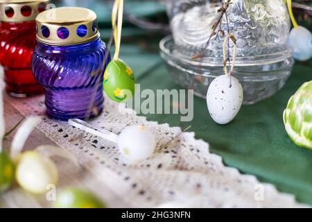 Painted Easter eggs and candles, multicolored, vintage, on a wood table Stock Photo