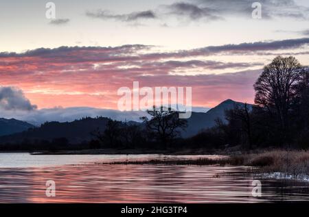 Red sky at sunrise over Bassenthwaite Lake, Lake District, Cumbria, England Stock Photo