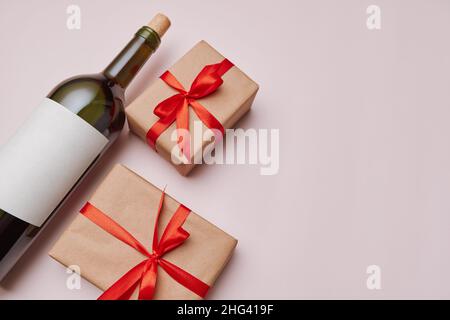 boxes with gifts and a bottle of wine on a light background. Stock Photo