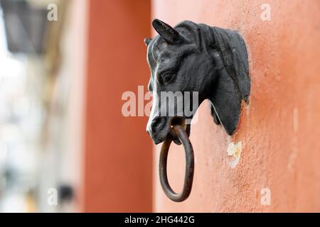 Detail of an ancient door knocker near one of the main entrance gates to the Cathedral of Seville, Spain. Shallow Deep of Field Stock Photo