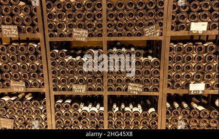 Monthelie, France - June 30, 2020: Wine bottles in the cellar of the domaine Boussy, Monthalie, burgundy, France. Stock Photo