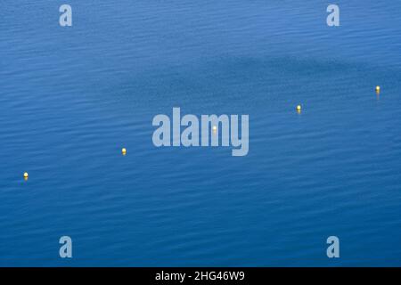 line of yellow buoys in the water. Delimiting aquatic spaces Stock Photo