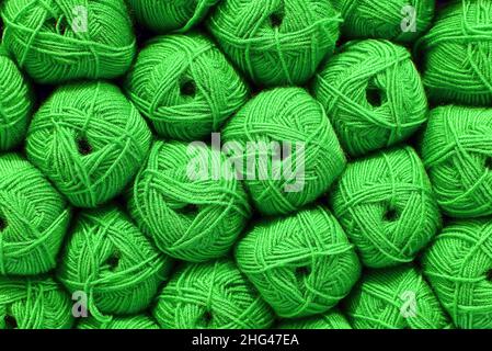 Green Ball of wool. Beautiful colored wools ball. Wool texture. Skeins of yarn. Natural material for knitting, creative idea. Abstract diy background. Stock Photo