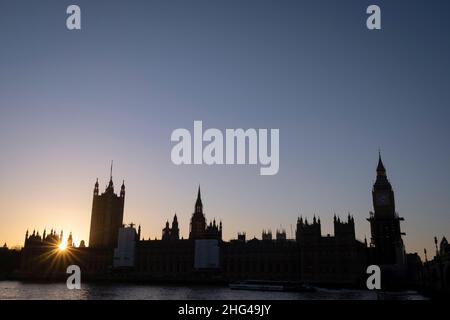 Still undergoing repairs to its roof and structure, the architecture of the British Houses of Parliament are seen in silhouette, on 17th January 2022, in London, England. The Big Ben bell contained inside the Elizabeth Tower has been silent since 2017 but is slowly being uncovered after extensive renovation work by contractor Sir Robert McAlpine - the estimated cost of repairing the tower and other parts of the 19th century Gothic building, has doubled to £61m, authorities have said. Stock Photo