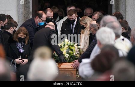 Family members place their hands on the coffin as it is carried out of St Brigid's Church, Mountbolus, Co Offaly, after the funeral of Ashling Murphy who was murdered in Tullamore, Co Offaly last Wedensday. 23-year-old Ashling, a primary school teacher and a talented musician, was found dead after going for a run on the banks of the Grand Canal in Tullamore. Picture date: Tuesday January 18, 2022. Stock Photo