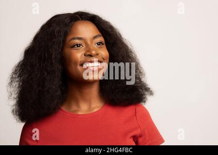 Beautiful Dreamy Young African American Woman Smiling And Looking Away Stock Photo