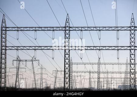 High voltage transmission lines on metallic poles in Bucharest, Romania. Stock Photo