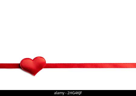 Creative Valentines Day postcard design with red ribbon and red textile heart on white background isolated. Valentine day and love concept Stock Photo