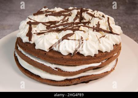 Cake, whole round black forest isolated, baked goods cherry cream chocolate design on white plate Stock Photo