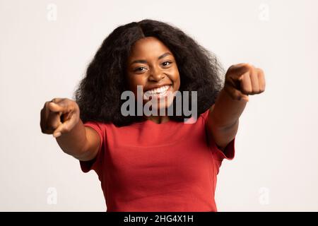 Portrait Of Joyful Young African American Female Pointing Two Fingers At Camera Stock Photo