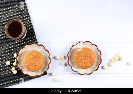 Flat Lay Mid Autumn Festival Mooncake and Tea Still Life on White Textured Background. Copy Space Stock Photo